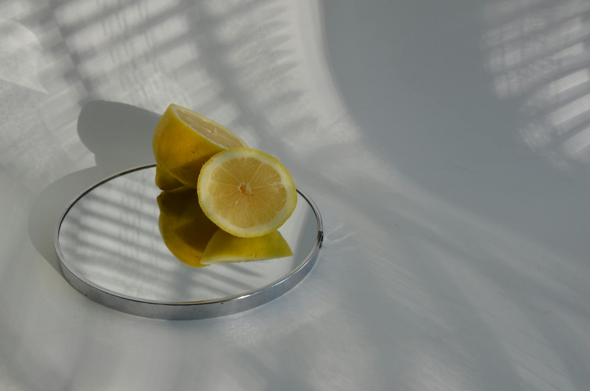 Sliced lemons on a mirror, symbolizing clarity and fresh sensation